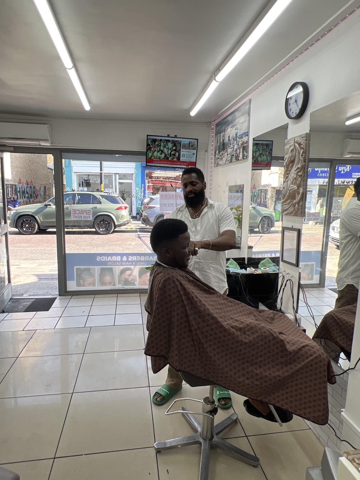 The salon floor seen wide and empty, daylight coming in from the shopfront