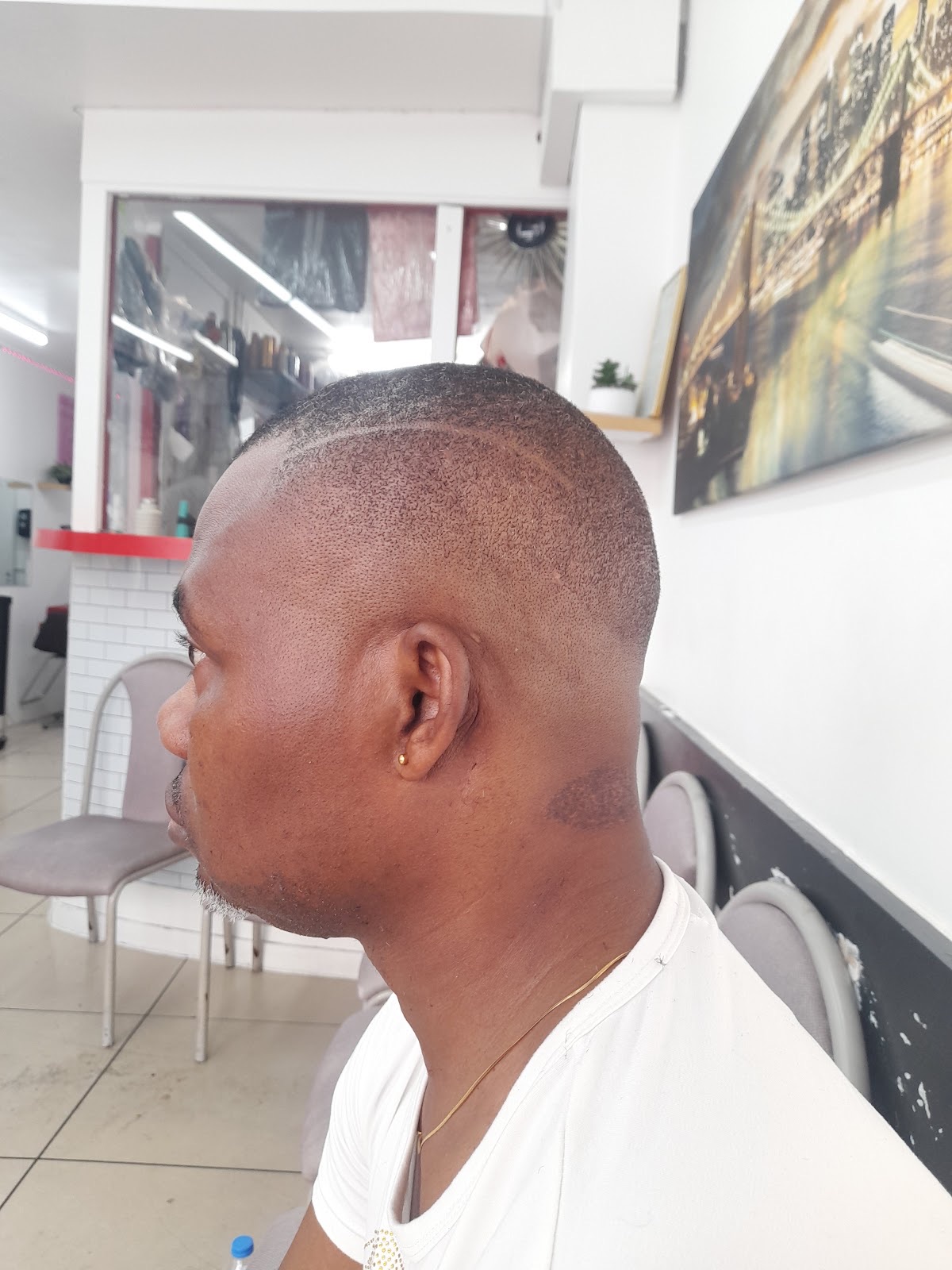 Side profile of a freshly cut fade, showing the clean taper and sharp hairline